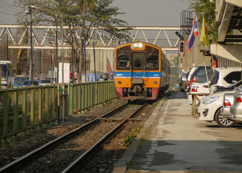 Train arrives at Thailand's Don Muang train station.